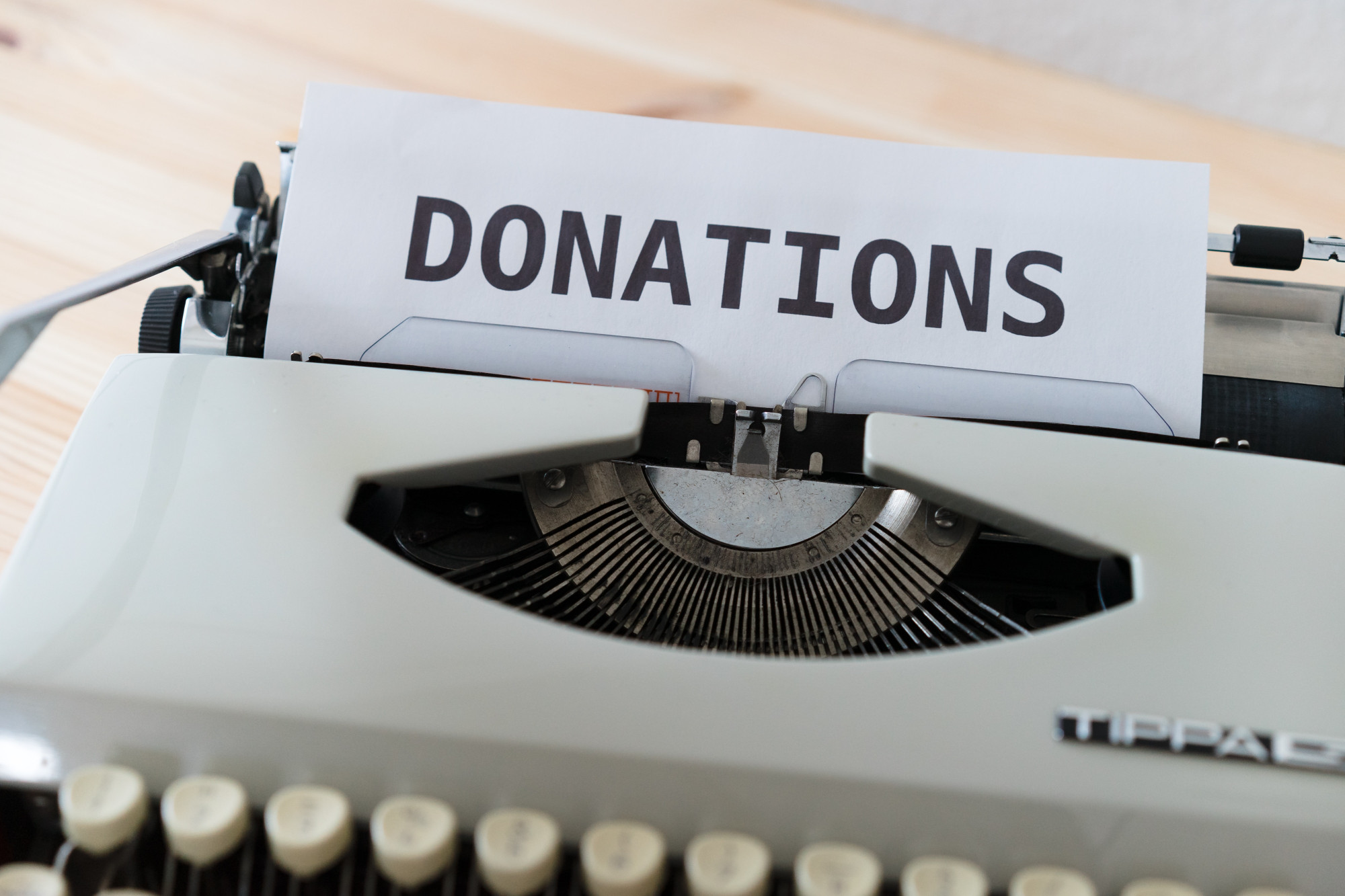 Typewriter with paper the word donations 