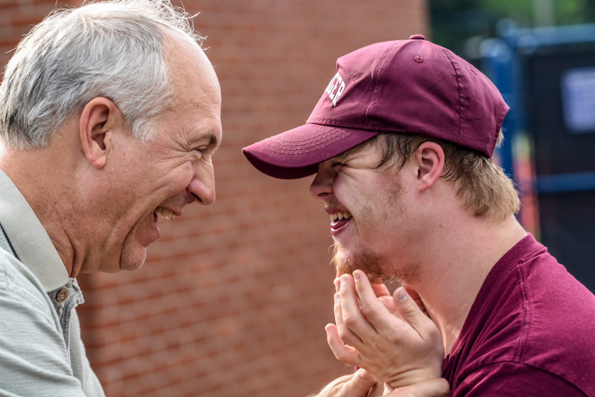 Father and son embracing smiling